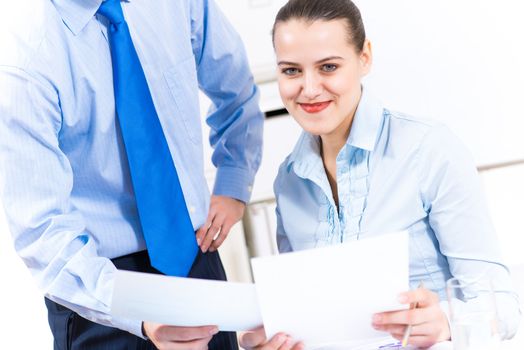 colleagues discuss the reports at a desk in the office, working together in business