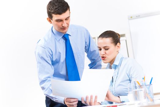 colleagues discuss the reports at a desk in the office, working together in business