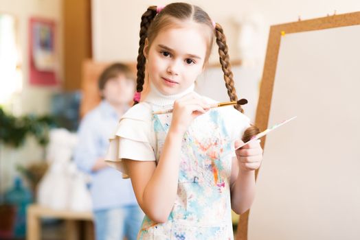 portrait of a girl standing next to his easel, a drawing lesson