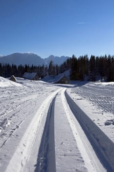 The road covered by the snow in mountains