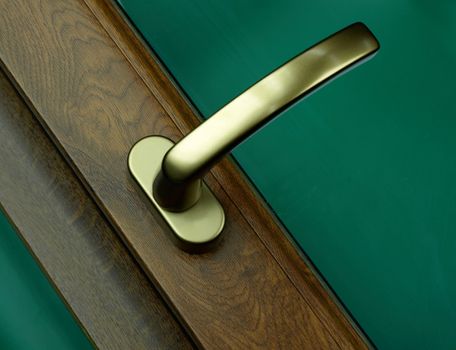 An elegant handle of the wooden door