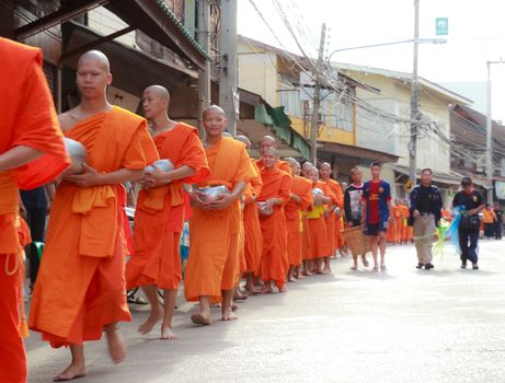 Phrae,Thailand - October 31,2012 : Unidentified Buddhist monks is given food offering from people at the morning on End of Buddhist Lent Day. on october 31, 2011 in Muang, Phrae, Thailand.