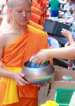 Phrae,Thailand - October 31,2012 : Unidentified Buddhist monks is given food offering from people at the morning on End of Buddhist Lent Day. on october 31, 2011 in Muang, Phrae, Thailand.