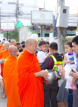 Phrae,Thailand - October 31,2012 : Unidentified Buddhist monks is given food offering from people at the morning on End of Buddhist Lent Day. on october 31, 2011 in Muang, Phrae, Thailand.