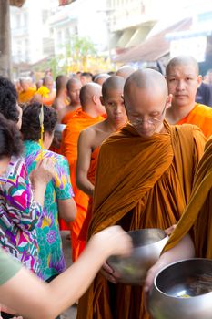 Phrae,Thailand - October 31,2012 : Unidentified Buddhist monks is given food offering from people at the morning on End of Buddhist Lent Day. on october 31, 2011 in Muang, Phrae, Thailand.