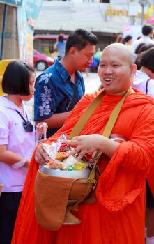 Phrae,Thailand - October 31,2012 : Unidentified Buddhist monks is given food offering from people at the morning on End of Buddhist Lent Day. on october 31, 2011 in Muang, Phrae, Thailand.