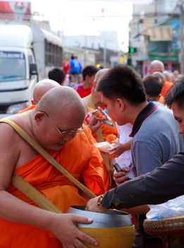 Phrae,Thailand - October 31,2012 : Unidentified Buddhist monks is given food offering from people at the morning on End of Buddhist Lent Day. on october 31, 2011 in Muang, Phrae, Thailand.