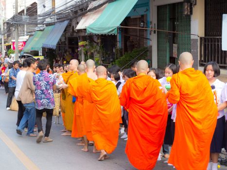 Phrae,Thailand - October 31,2012 : Unidentified Buddhist monks is given food offering from people at the morning on End of Buddhist Lent Day. on october 31, 2011 in Muang, Phrae, Thailand.