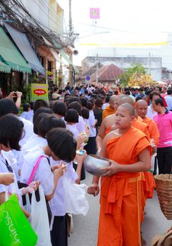 Phrae,Thailand - October 31,2012 : Unidentified Buddhist monks is given food offering from people at the morning on End of Buddhist Lent Day. on october 31, 2011 in Muang, Phrae, Thailand.