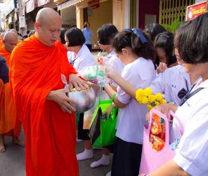 Phrae,Thailand - October 31,2012 : Unidentified Buddhist monks is given food offering from people at the morning on End of Buddhist Lent Day. on october 31, 2011 in Muang, Phrae, Thailand.