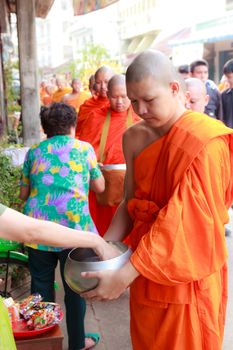 Phrae,Thailand - October 31,2012 : Unidentified Buddhist monks is given food offering from people at the morning on End of Buddhist Lent Day. on october 31, 2011 in Muang, Phrae, Thailand.