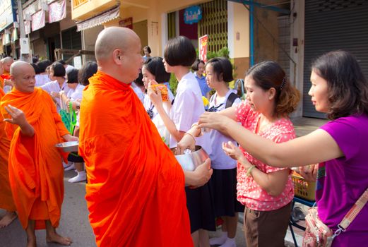 Phrae,Thailand - October 31,2012 : Unidentified Buddhist monks is given food offering from people at the morning on End of Buddhist Lent Day. on october 31, 2011 in Muang, Phrae, Thailand.