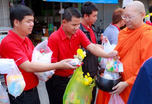 Phrae,Thailand - October 31,2012 : Unidentified Buddhist monks is given food offering from people at the morning on End of Buddhist Lent Day. on october 31, 2011 in Muang, Phrae, Thailand.