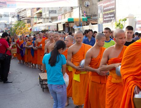 Phrae,Thailand - October 31,2012 : Unidentified Buddhist monks is given food offering from people at the morning on End of Buddhist Lent Day. on october 31, 2011 in Muang, Phrae, Thailand.