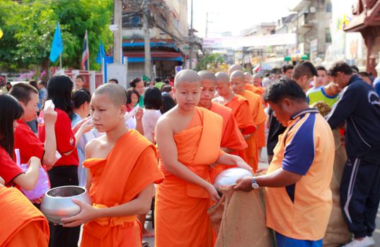 Phrae,Thailand - October 31,2012 : Unidentified Buddhist monks is given food offering from people at the morning on End of Buddhist Lent Day. on october 31, 2011 in Muang, Phrae, Thailand.