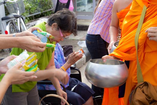 Phrae,Thailand - October 31,2012 : Unidentified Buddhist monks is given food offering from people at the morning on End of Buddhist Lent Day. on october 31, 2011 in Muang, Phrae, Thailand.