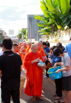 Phrae,Thailand - October 31,2012 : Unidentified Buddhist monks is given food offering from people at the morning on End of Buddhist Lent Day. on october 31, 2011 in Muang, Phrae, Thailand.