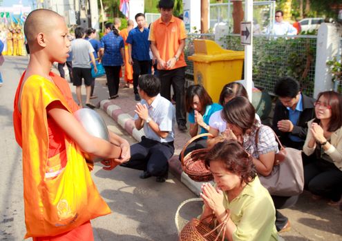 Phrae,Thailand - October 31,2012 : Unidentified Buddhist monks is given food offering from people at the morning on End of Buddhist Lent Day. on october 31, 2011 in Muang, Phrae, Thailand.
