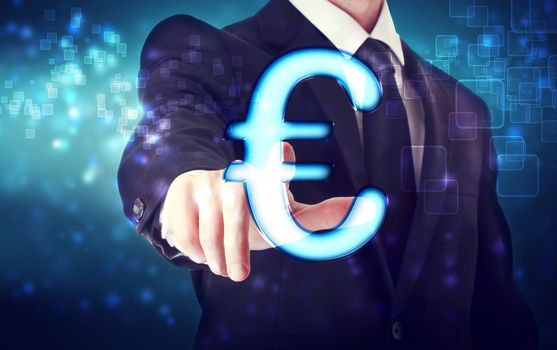 Businessman pointing Euro icon with blue tech background