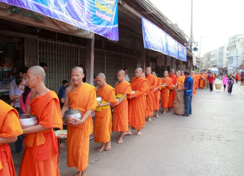 Phrae,Thailand - October 31,2012 : Unidentified Buddhist monks is given food offering from people at the morning on End of Buddhist Lent Day. on october 31, 2011 in Muang, Phrae, Thailand.