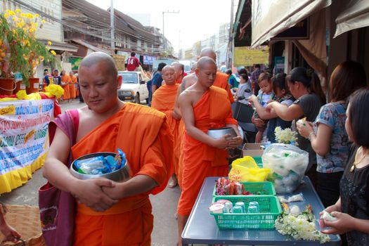 Phrae,Thailand - October 31,2012 : Unidentified Buddhist monks is given food offering from people at the morning on End of Buddhist Lent Day. on october 31, 2011 in Muang, Phrae, Thailand.