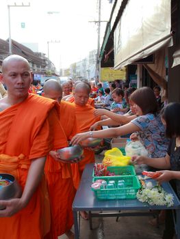 Phrae,Thailand - October 31,2012 : Unidentified Buddhist monks is given food offering from people at the morning on End of Buddhist Lent Day. on october 31, 2011 in Muang, Phrae, Thailand.