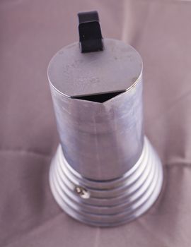 Close up of a cup of a metal coffeepot 