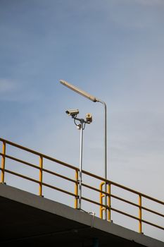 CCTV security cams at carpark and blue sky.