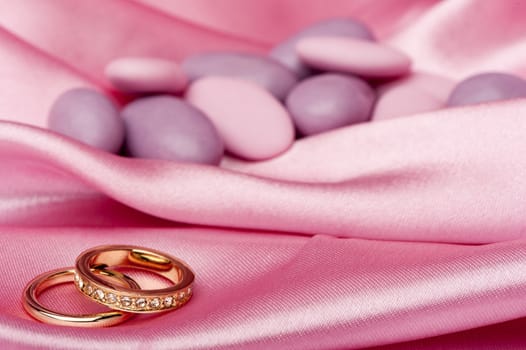  wedding rings on  a colorful fabric background