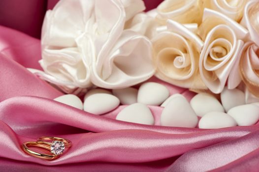  wedding rings on  a colorful fabric background