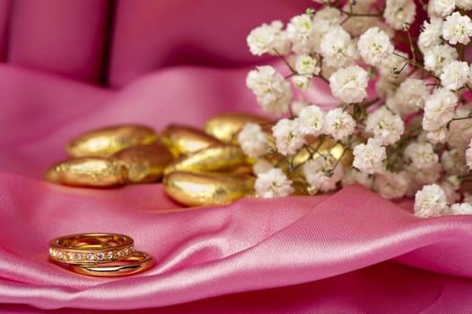  wedding rings on  a colorful fabric background