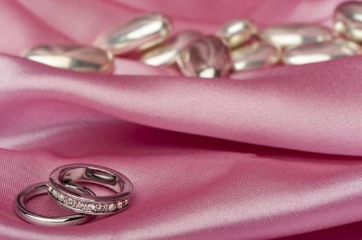  wedding rings on  a colorful fabric background