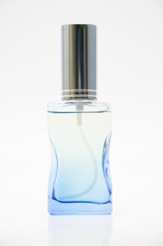 Glass blue perfume bottles on white background.