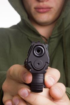 Gun in the hands of a gunman aimed shot.