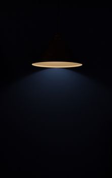 A glowing lamp in a dark room
