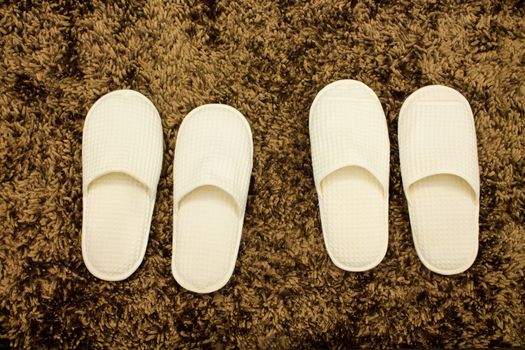 white slippers ON BROWN MATTE