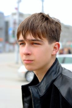 The excited teenager looks aside with attention on the street