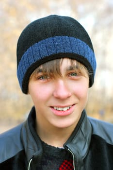 smiling teenager stand in the autumn park