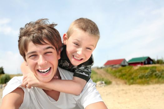 happy teenager and kid on the beach