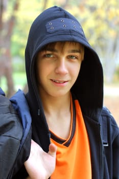 smiling teenager stand in the autumn park