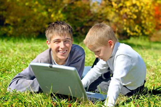 brothers with notebook on the meadow