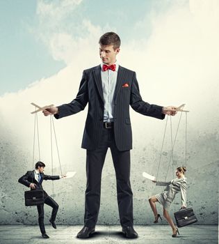 Image of young businessman puppeteer. Leadership concept