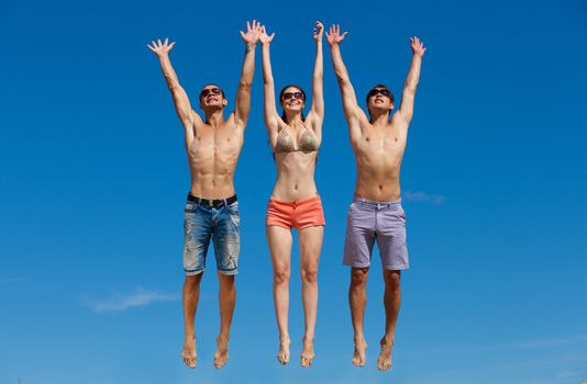 Happy group of friends at the beach