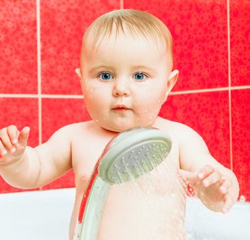 cute smiling baby in bath with shower