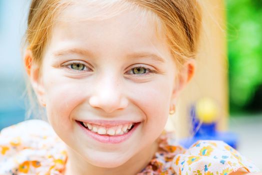 portrait of a cute smiling little girl close up