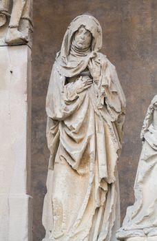 Close up of the carving of Mary, mother of Jesus by ancient stone carved crucifixes in Bad Wimpfen, Germany. This Crucifixion group is the work of Mainz sculptor Hans Backoffen in about 1515.