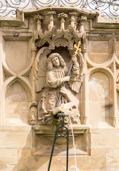 Statue from fountain at Schwabisch Hall, Germany. Dating from 1509, the fountain stands against a decorative wall adorned with statues of Samson, St Michael and St George. The rectangular design, unusual in a Gothic fountain, includes the old pillory post.