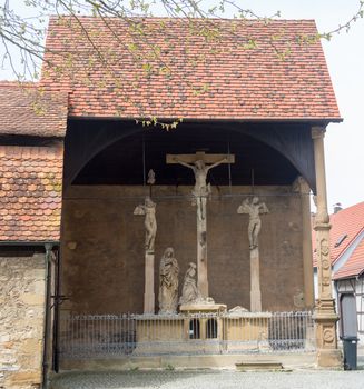 Close up of the ancient stone carved crucifixes. This Crucifixion group is the work of Mainz sculptor Hans Backoffen in about 1515.