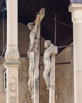 Side view of the ancient stone carved crucifixes in Bad Wimpfen, Germany. This Crucifixion group is the work of Mainz sculptor Hans Backoffen in about 1515.