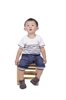 Cute asian boy sitting on bamboo stools